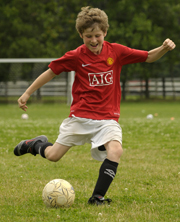 A young soccer player prepares to strike a ball